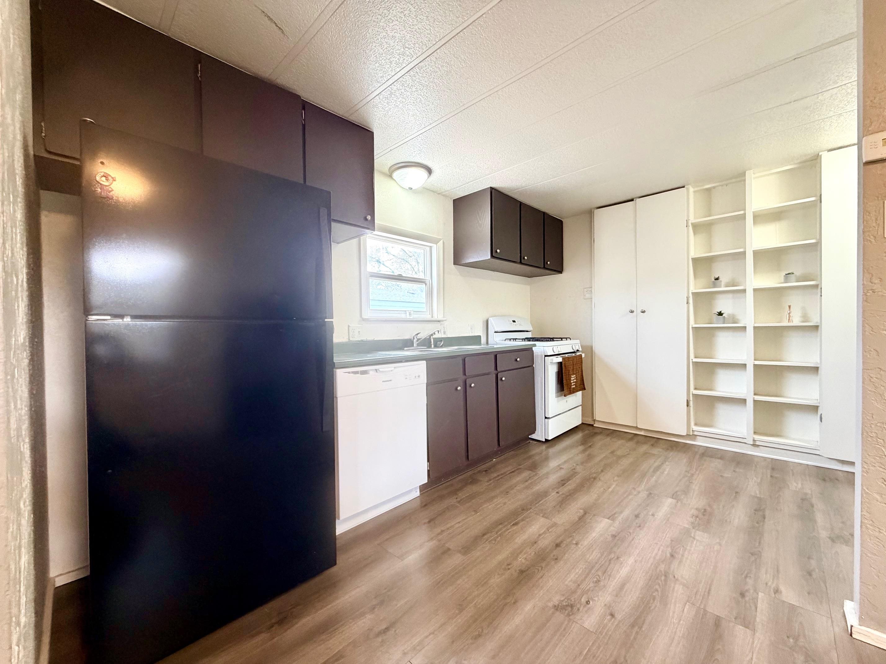 585-25 25 1/2 Road, Unit 237 Grand Junction, CO 81505 - Photo 16 of 31 a view of a kitchen with wooden floor and electronic appliances