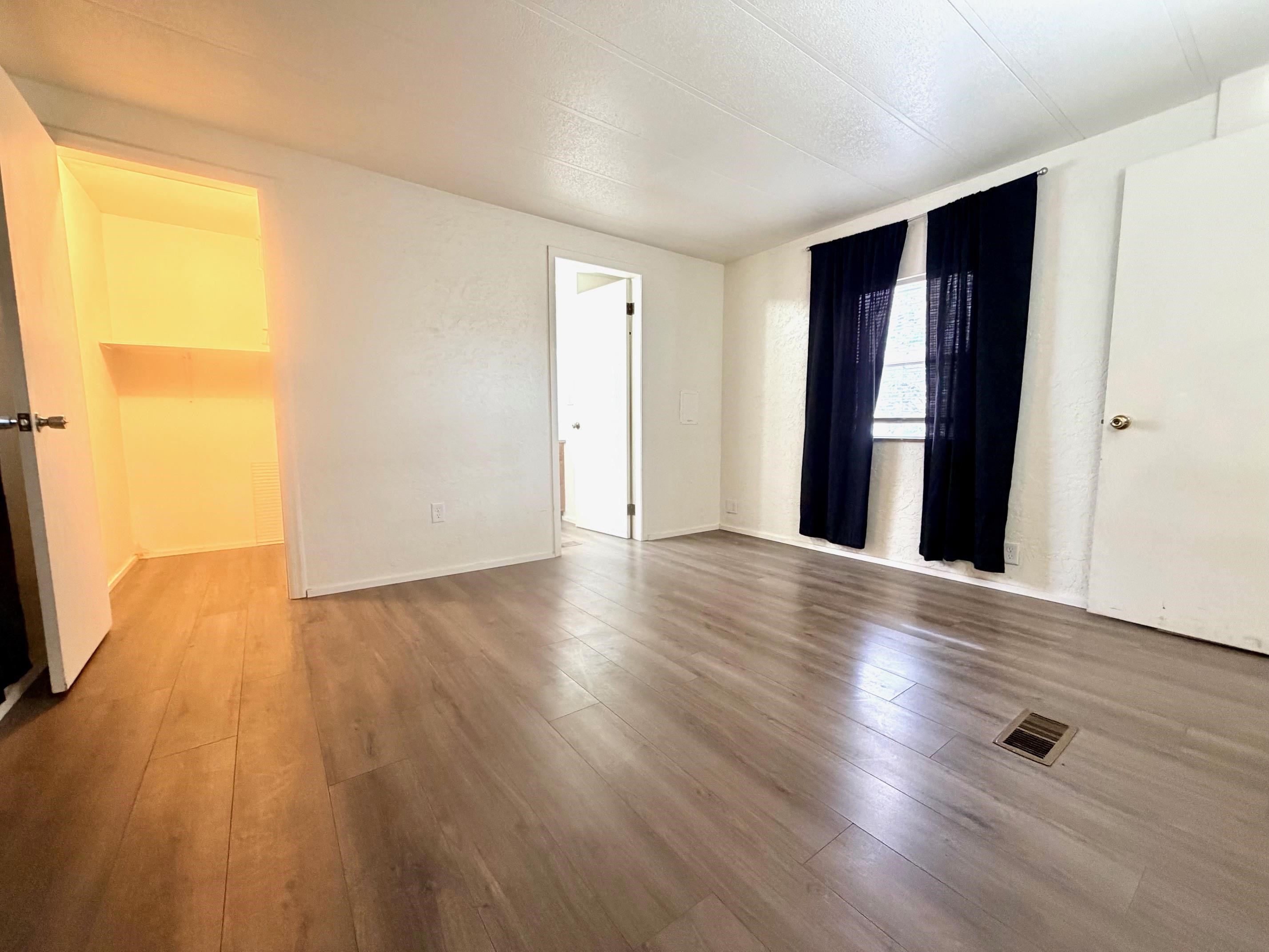 585-25 25 1/2 Road, Unit 237 Grand Junction, CO 81505 - Photo 18 of 31 an empty room with wooden floor and windows