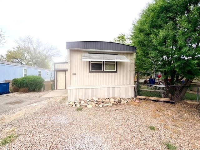 585-25 25 1/2 Road, Unit 237 Grand Junction, CO 81505 - Photo 2 of 31 a backyard of a house with table and chairs