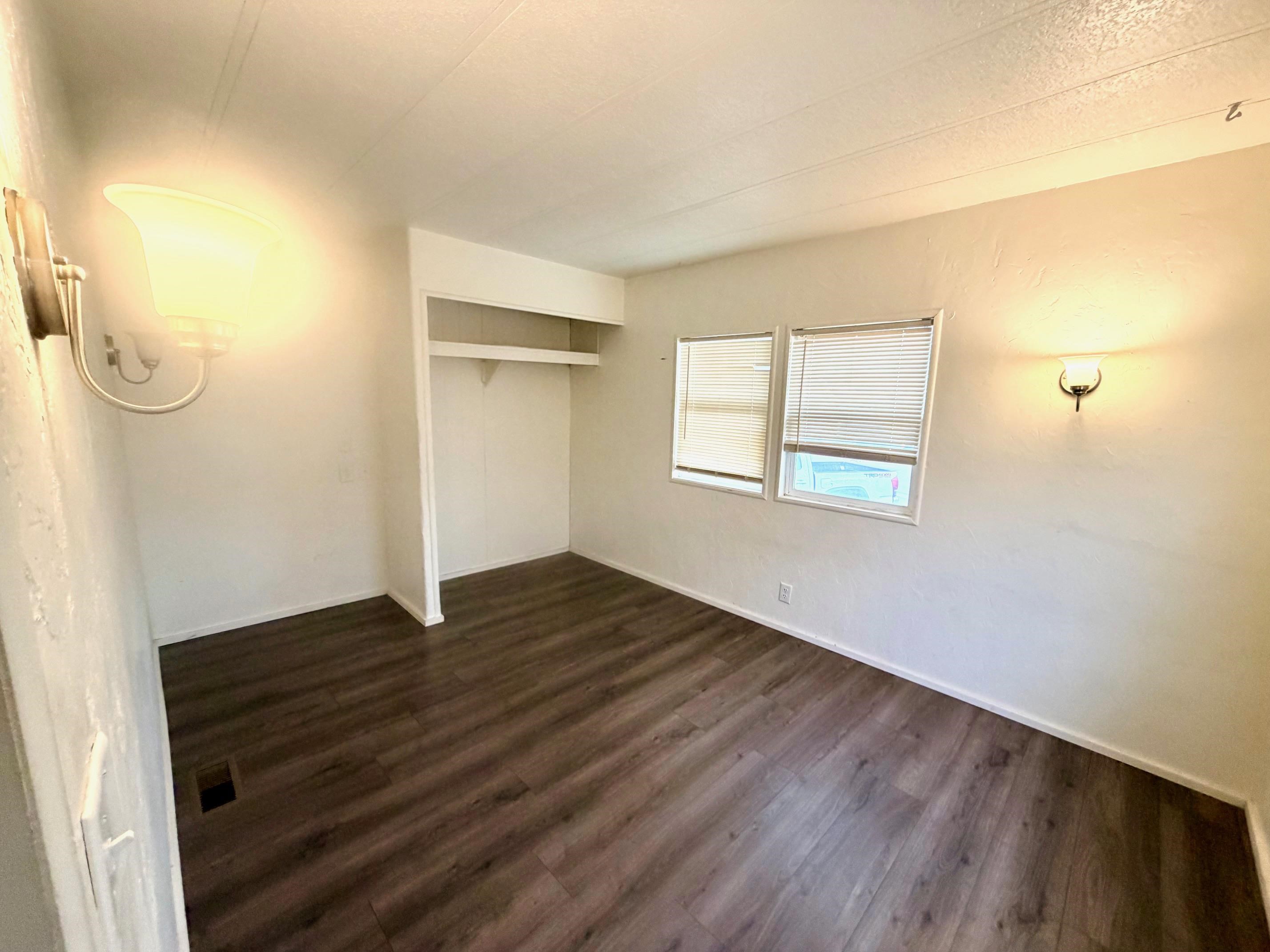 585-25 25 1/2 Road, Unit 237 Grand Junction, CO 81505 - Photo 26 of 31 an empty room with wooden floor and windows