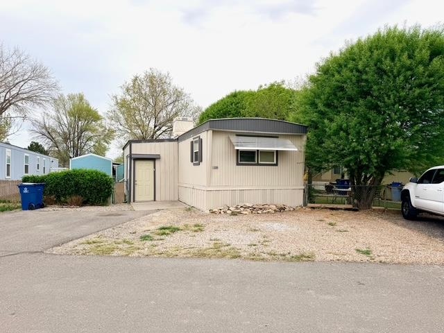 585-25 25 1/2 Road, Unit 237 Grand Junction, CO 81505 - Photo 30 of 31 a white house that has a tree in front of it