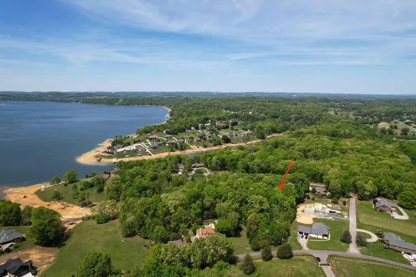 an aerial view of a house with a yard and garden
