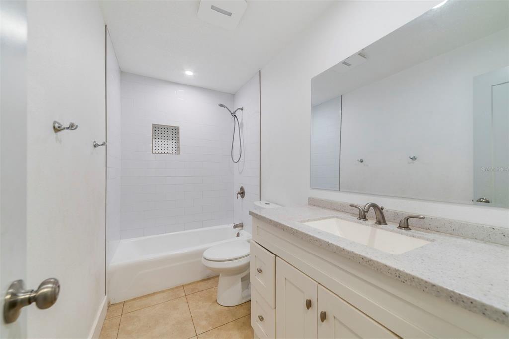 449 Citadel Drive Altamonte Springs, FL 32714 - Photo 11 of 25 a bathroom with a granite countertop sink a toilet and shower