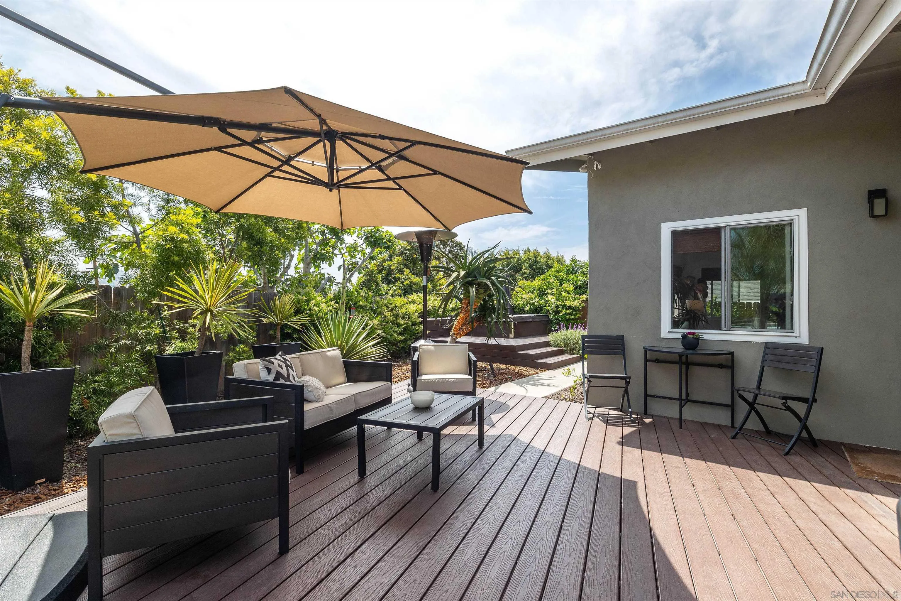 5775 Derk Drive La Mesa, CA 91942 - Photo 18 of 21 a patio with wooden floor a yard a table and chairs