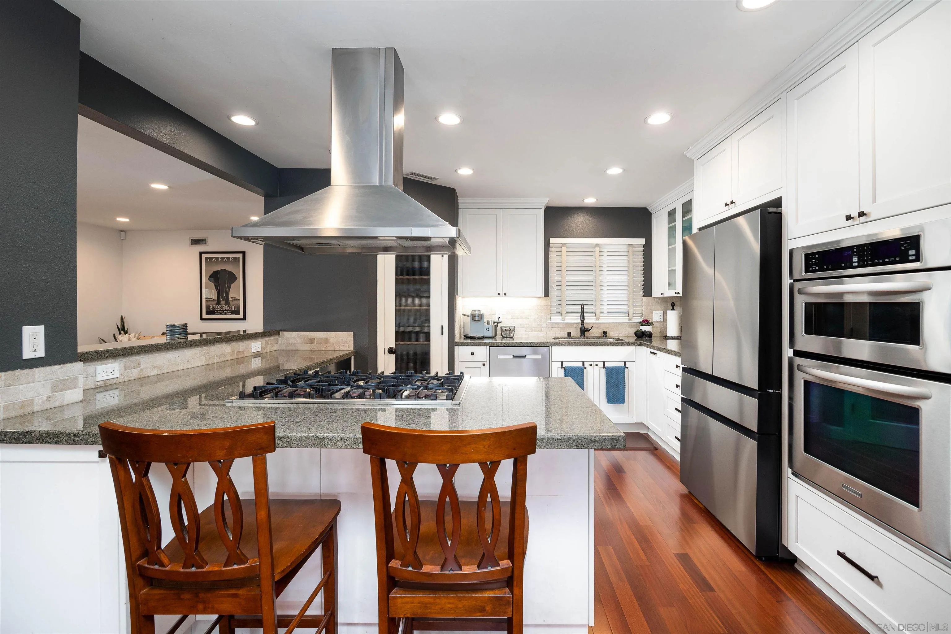 5775 Derk Drive La Mesa, CA 91942 - Photo 8 of 21 a kitchen with granite countertop a dining table chairs refrigerator and microwave