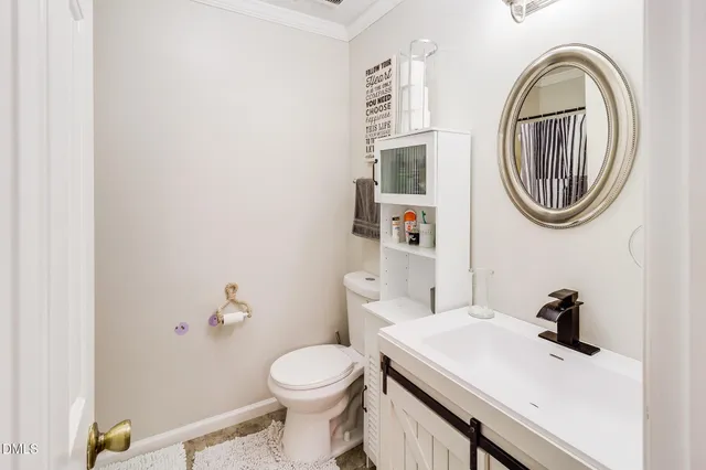 a bathroom with a sink a toilet and a mirror