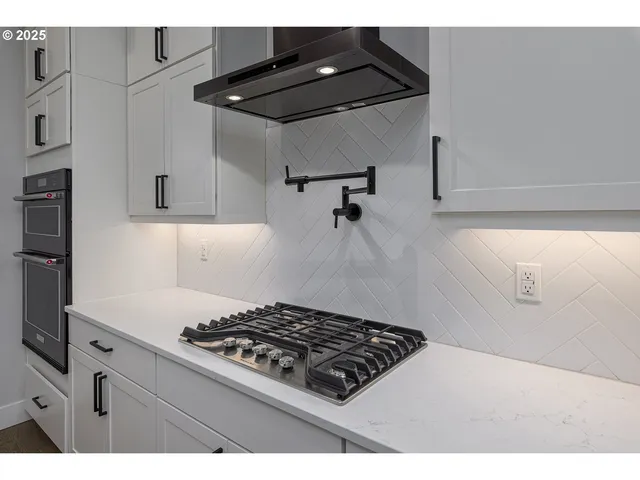 a kitchen with a stove and a refrigerator