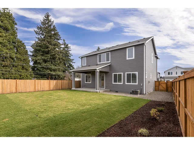 a backyard of a house with table and chairs
