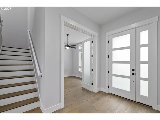 a view of an entryway with wooden floor