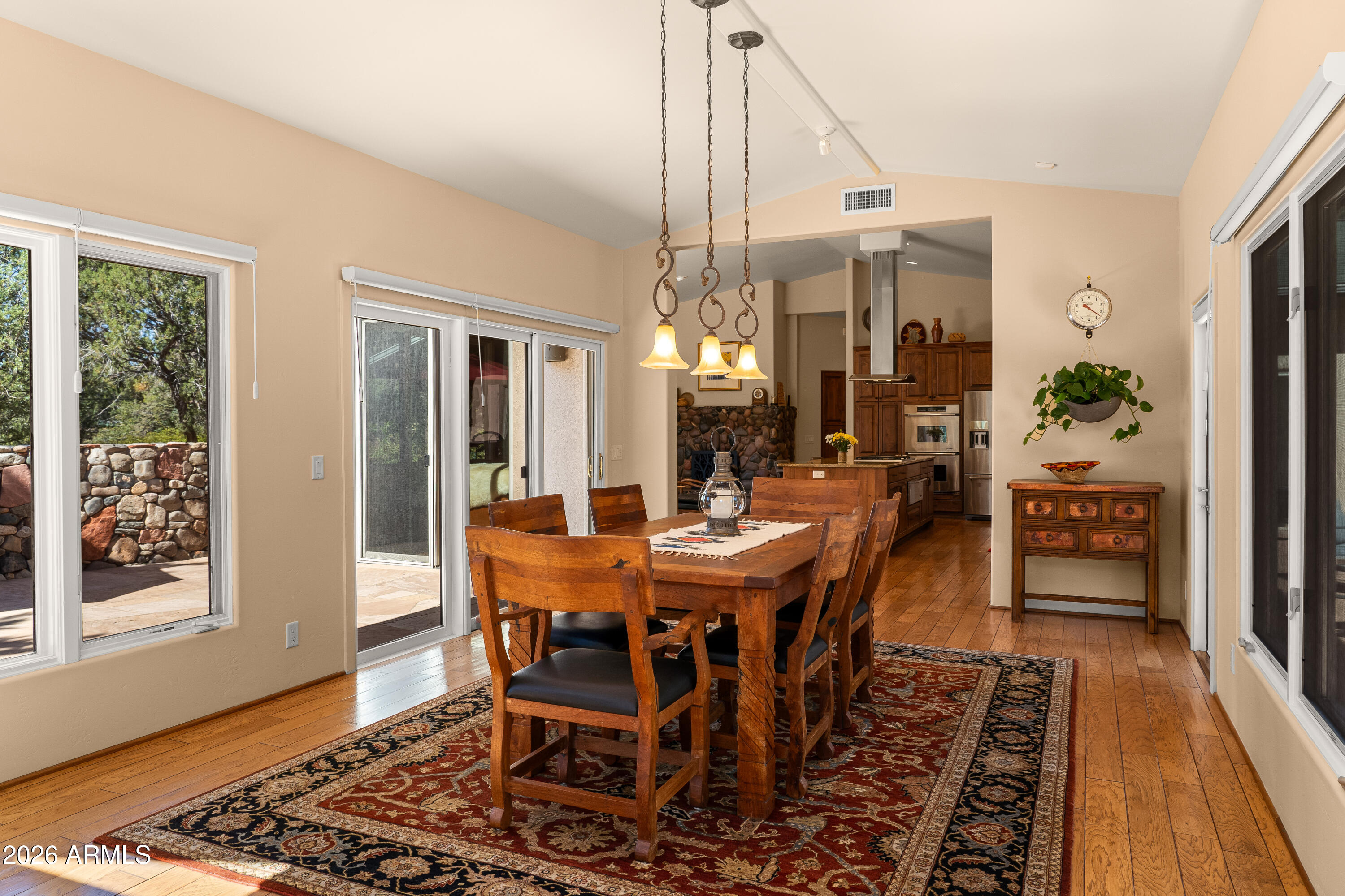 190 Morgan Road Sedona, AZ 86336 - Photo 34 of 51 a dining room with furniture wooden floor a rug and a chandelier
