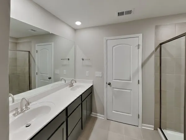 a bathroom with a double vanity sink and mirror