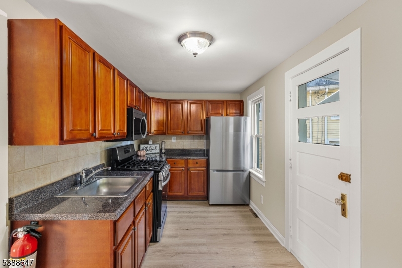 330 Chambers Street Phillipsburg, NJ 08865 - Photo 12 of 27 a kitchen with stainless steel appliances granite countertop a sink stove and refrigerator