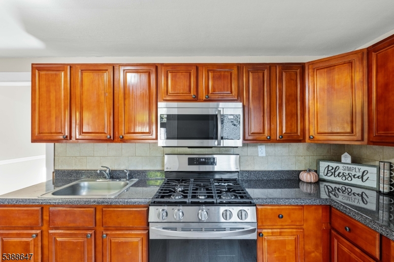 330 Chambers Street Phillipsburg, NJ 08865 - Photo 13 of 27 a kitchen with stainless steel appliances granite countertop a stove a sink and a microwave