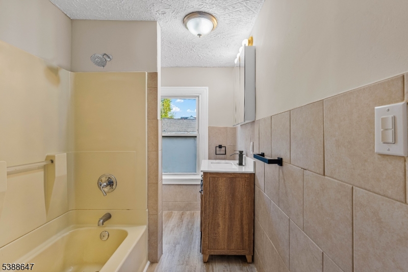 330 Chambers Street Phillipsburg, NJ 08865 - Photo 16 of 27 a bathroom with a tub shower and sink