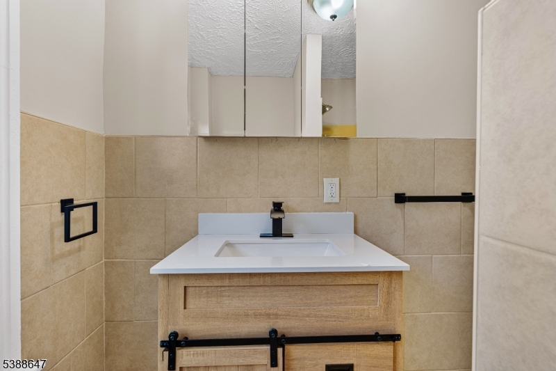 330 Chambers Street Phillipsburg, NJ 08865 - Photo 17 of 27 a bathroom with a sink a vanity and mirror