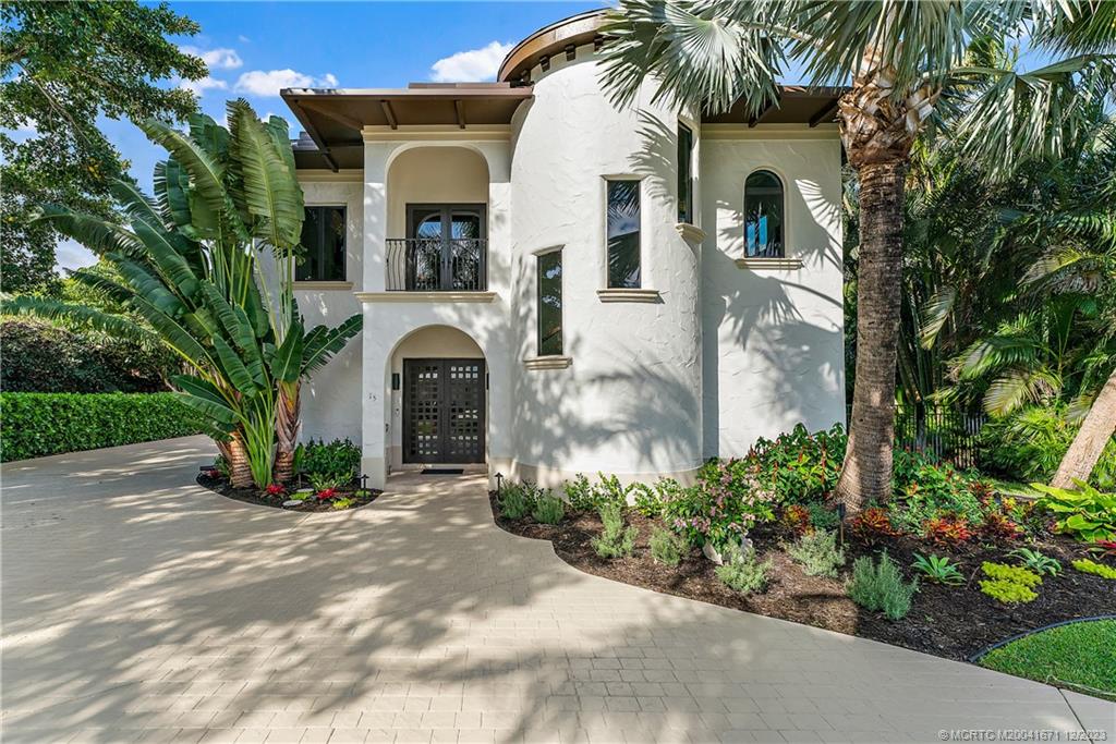 15 Middle Road Sewall's Point, FL 34996 - Photo 1 of 61 a front view of a house with a garden