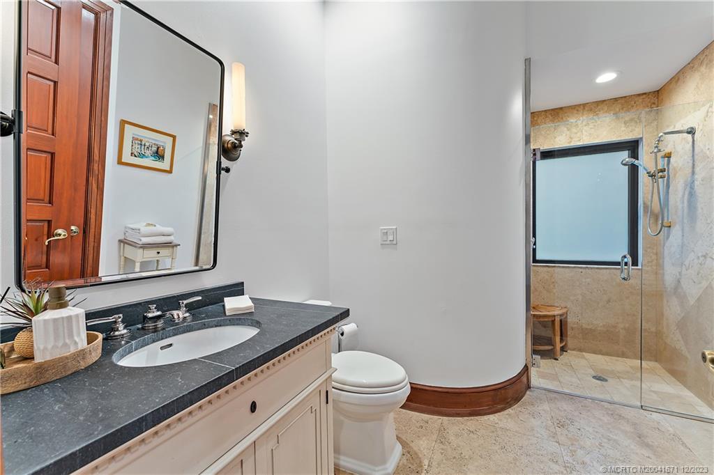 15 Middle Road Sewall's Point, FL 34996 - Photo 16 of 61 a bathroom with a granite countertop sink mirror vanity and toilet
