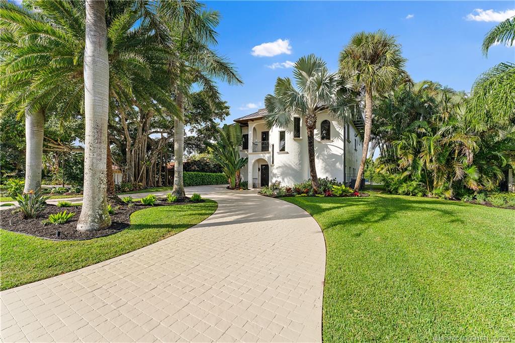 15 Middle Road Sewall's Point, FL 34996 - Photo 3 of 61 a front view of a house with a yard and fountain