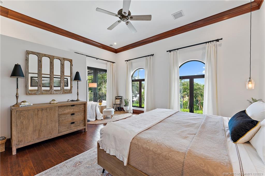 15 Middle Road Sewall's Point, FL 34996 - Photo 35 of 61 a spacious bedroom with a large bed and a window