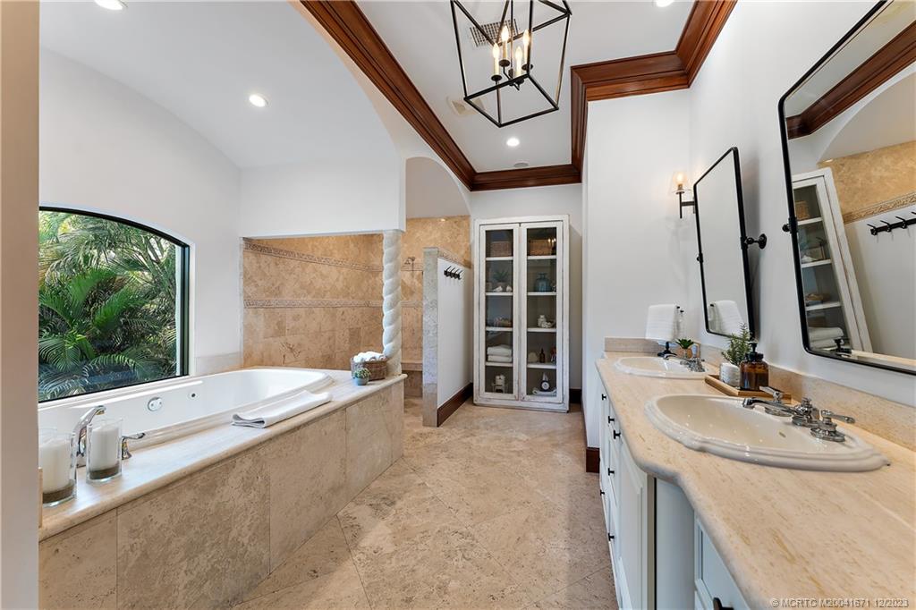 15 Middle Road Sewall's Point, FL 34996 - Photo 38 of 61 a spacious bathroom with a tub sink and mirror