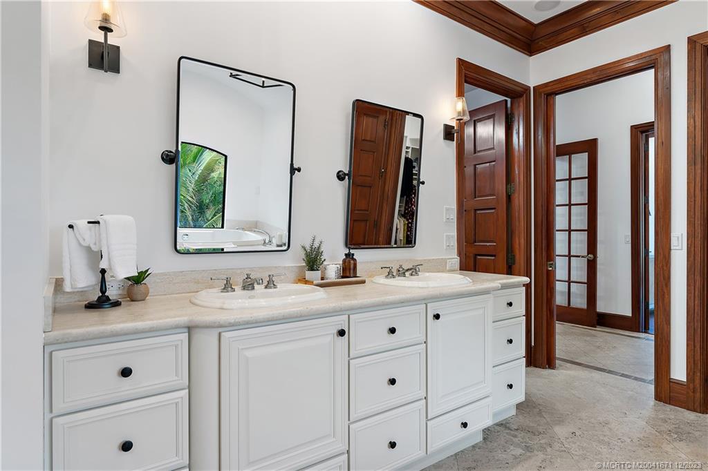 15 Middle Road Sewall's Point, FL 34996 - Photo 40 of 61 a bathroom with a double vanity sink and a mirror