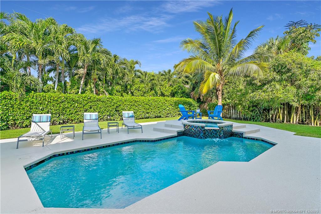 15 Middle Road Sewall's Point, FL 34996 - Photo 45 of 61 a view of a swimming pool with a garden and trees