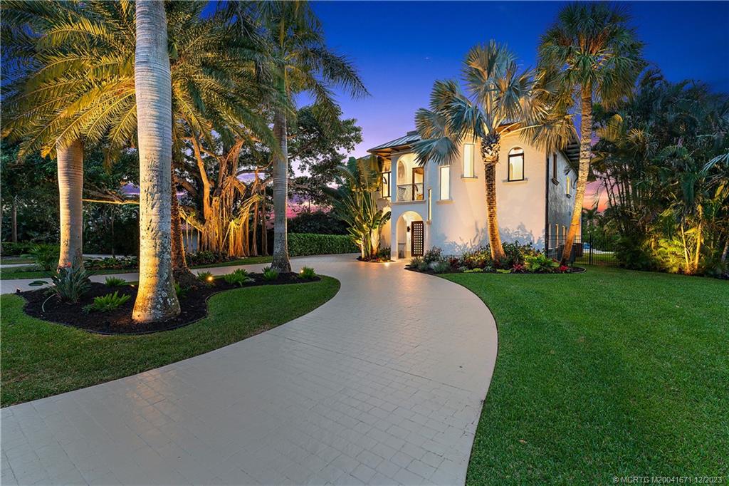 15 Middle Road Sewall's Point, FL 34996 - Photo 50 of 61 a view of a white house with a yard and palm trees