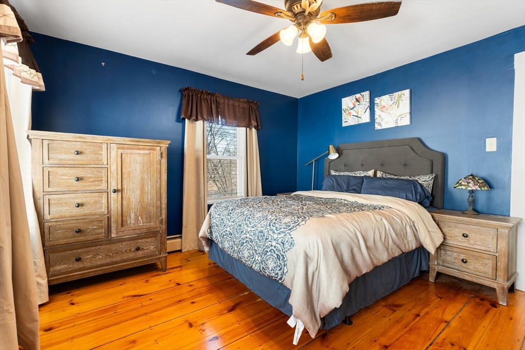 58 Saunders Street North Andover, MA 01845 - Photo 7 of 14 a bedroom with a bed and a chandelier