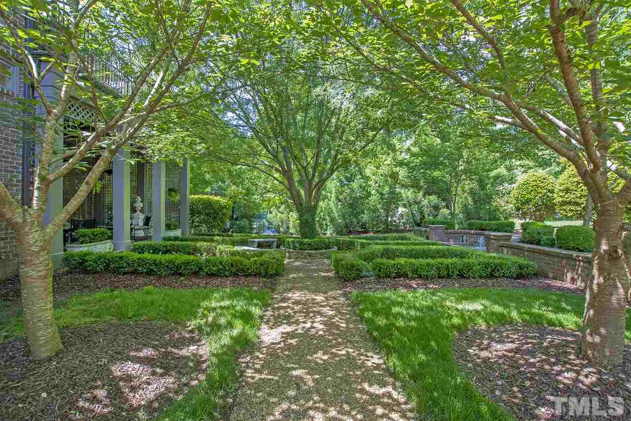 1016 Heydon Court Raleigh, NC 27614 - Photo 17 of 30 a view of a garden with plants and large trees