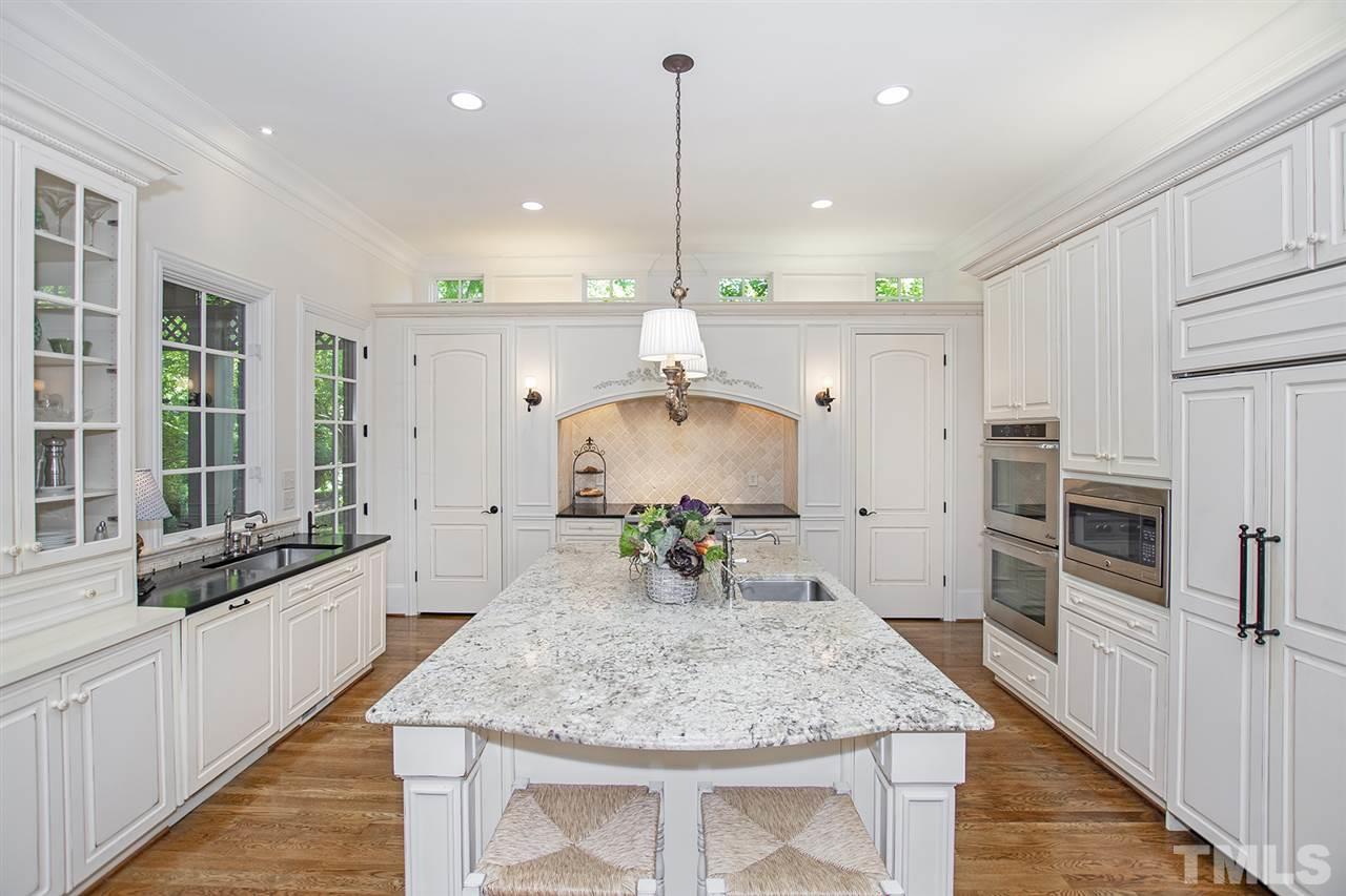 1016 Heydon Court Raleigh, NC 27614 - Photo 7 of 30 a kitchen with kitchen island a counter top space appliances and a ceiling fan