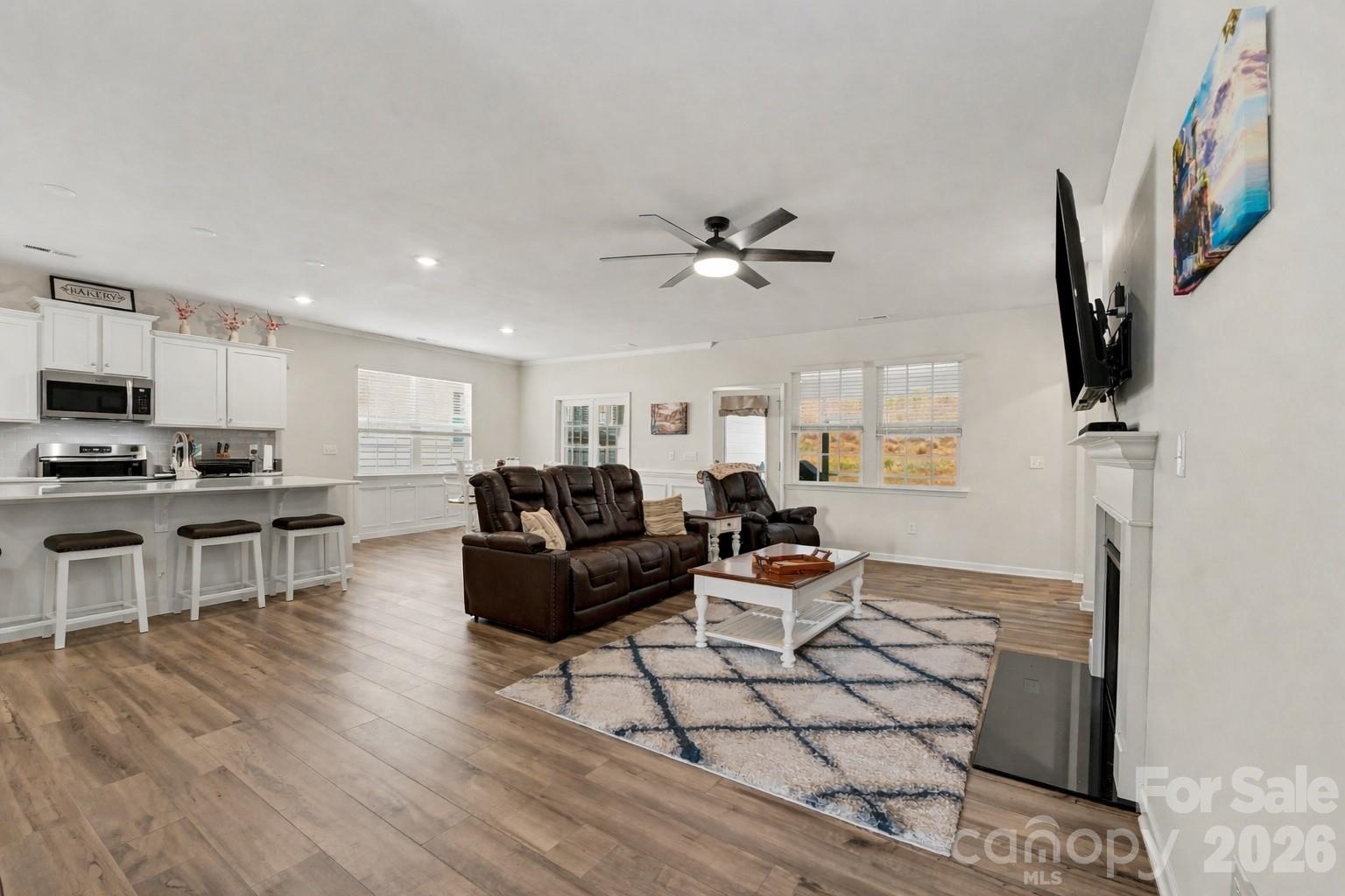 2971 Findley Road Statesville, NC 28625 - Photo 5 of 19 a living room with furniture a fireplace and a flat screen tv
