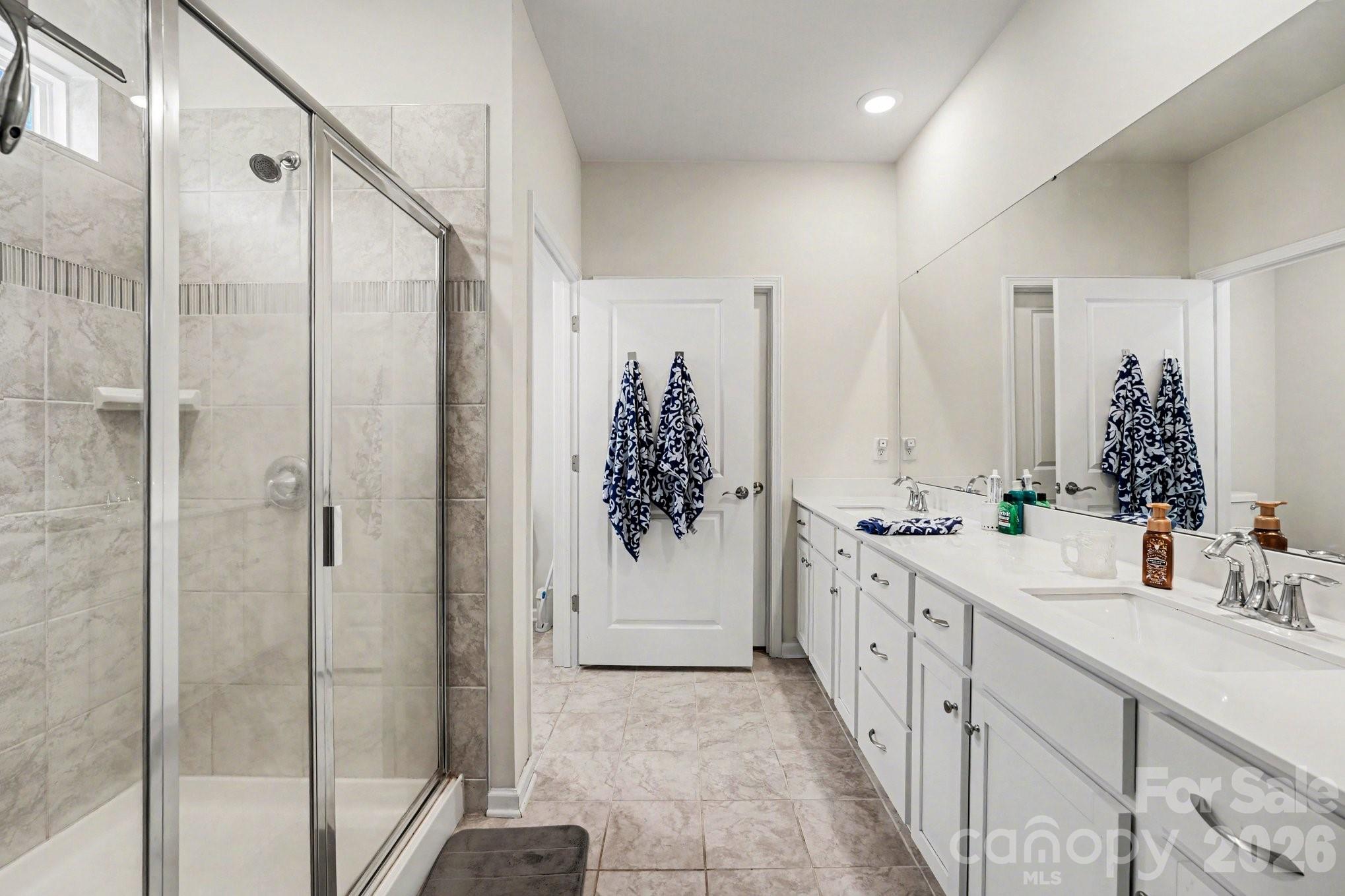 2971 Findley Road Statesville, NC 28625 - Photo 7 of 19 a bathroom with a double vanity sink and mirror