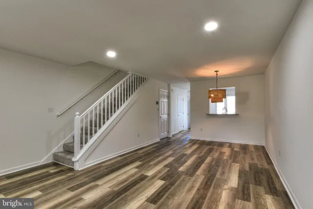 a view of an entryway with wooden floor