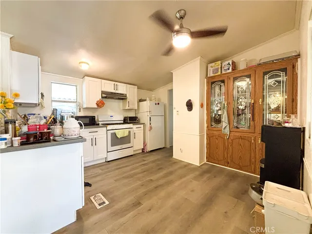 a kitchen with stainless steel appliances a refrigerator and a stove top oven