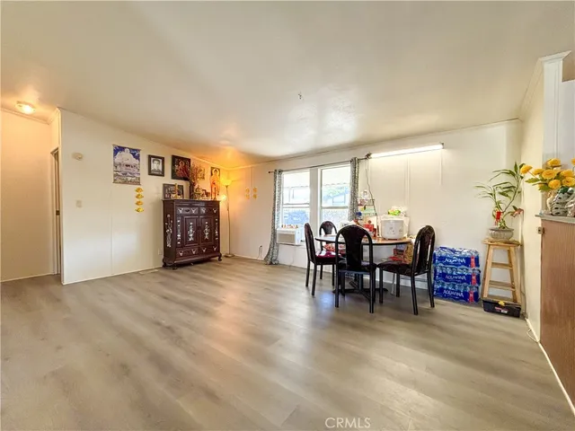 a view of a dining room with furniture and a potted plant