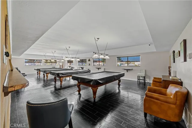 a living room with furniture and view of kitchen