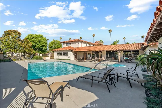 a view of a house with swimming pool and furniture