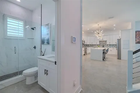 a view of kitchen with microwave oven stove and white cabinets