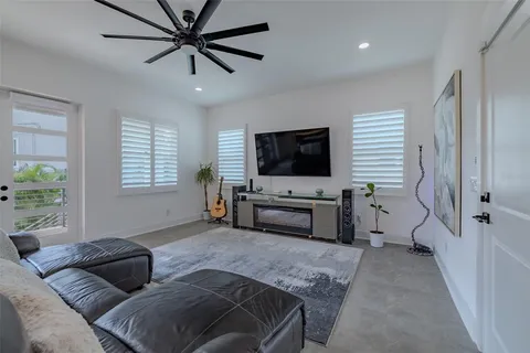 a kitchen with stainless steel appliances a stove and a flat screen tv