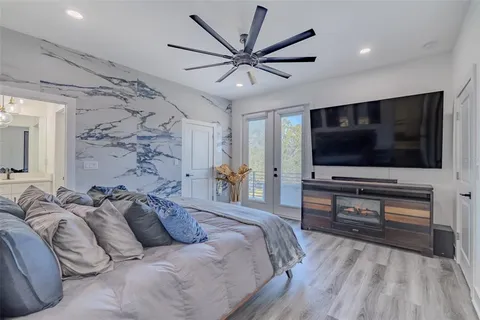 a spacious bedroom with a bed and a chandelier