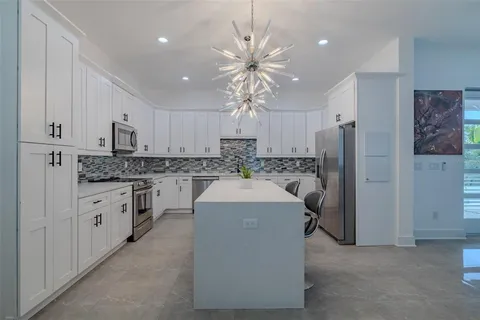 a kitchen that has a lot of cabinets in it