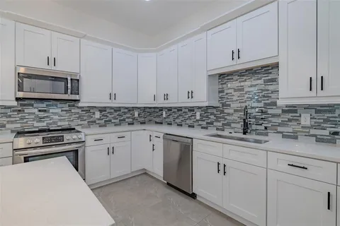 a view of a workspace with furniture and a chandelier