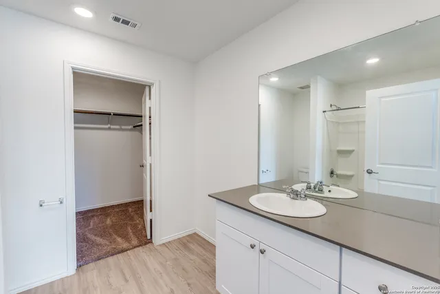 a bathroom with a sink double vanity and a mirror