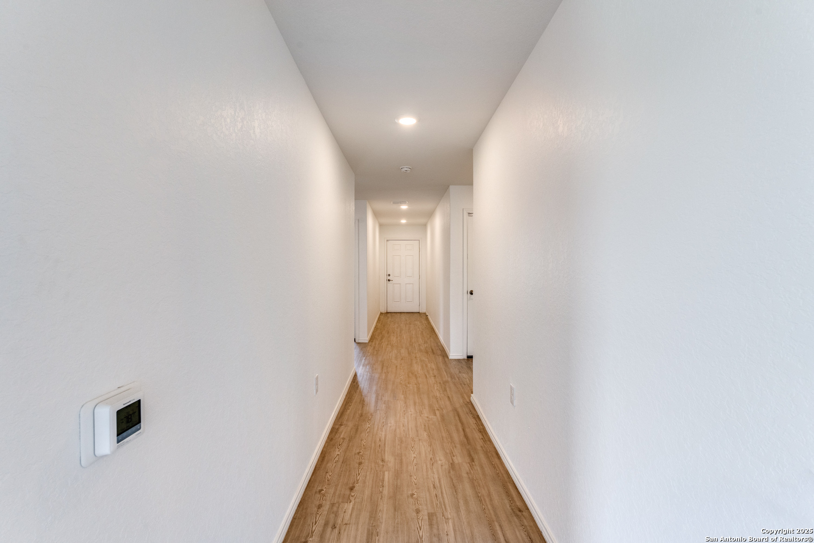 13503 Turnesa Terrace San Antonio, TX 78221 - Photo 18 of 25 a view of a hallway with wooden floor