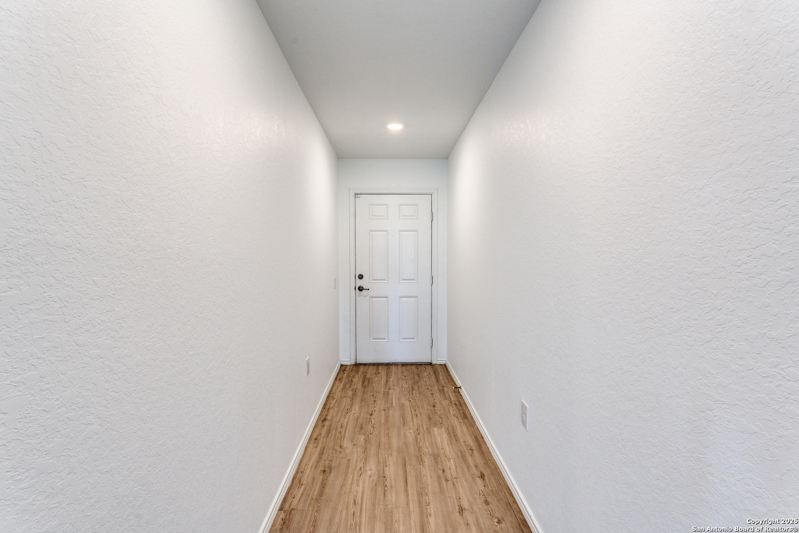13503 Turnesa Terrace San Antonio, TX 78221 - Photo 19 of 25 a view of a hallway with wooden floor