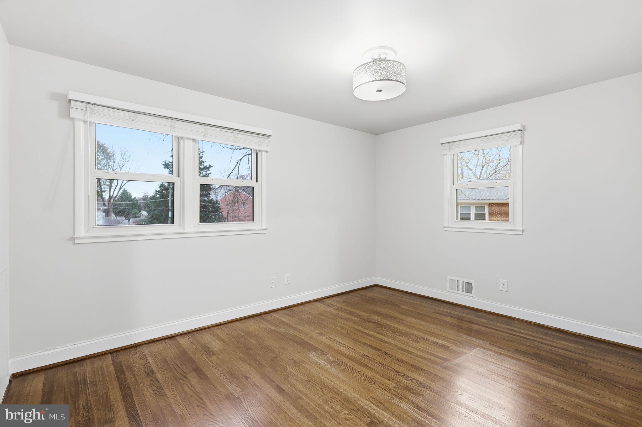 7114 Xavier Court McLean, VA 22101 - Photo 12 of 22 a view of empty room with wooden floor and fan