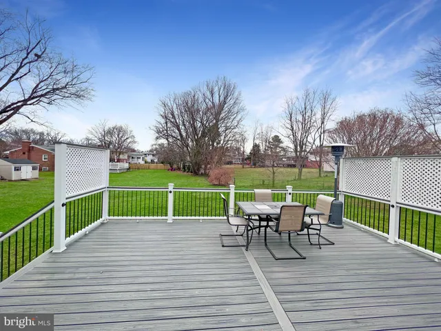 a view of house with deck and outdoor seating