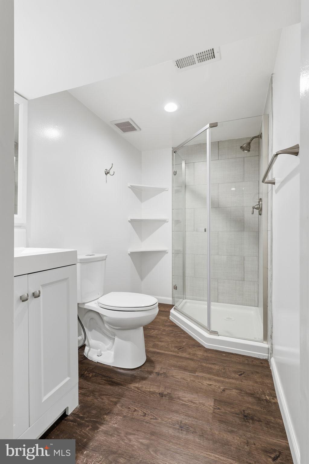 7114 Xavier Court McLean, VA 22101 - Photo 22 of 22 a white toilet sitting next to a bathroom sink