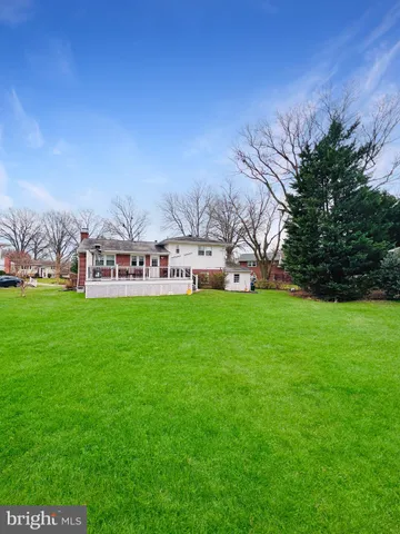 a view of house with garden space and trees