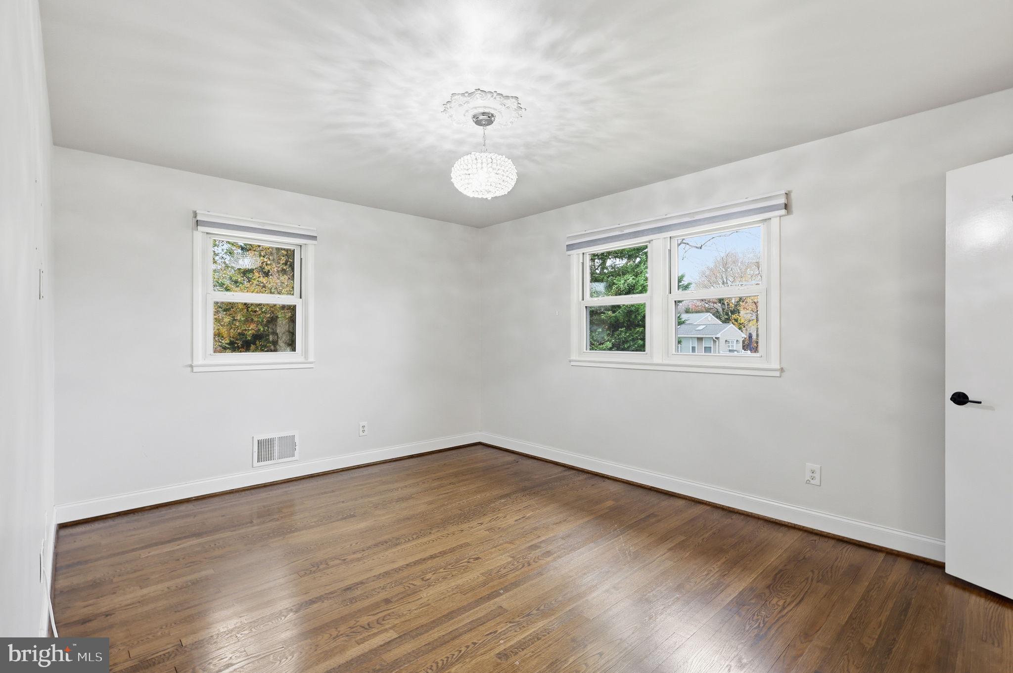 7114 Xavier Court McLean, VA 22101 - Photo 9 of 22 a view of an empty room with wooden floor and window